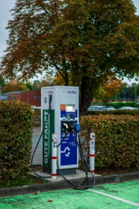 Electric car charging station with autumn trees